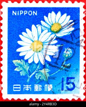 Photo of a 15 Japanese yen postage stamp with an illustration Ox-eye Daisy Leucanthemum vulgare from the 1966 Fauna Flora and Cultural heritage series Stock Photo