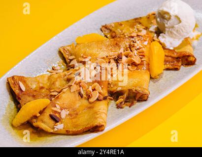 pancakes in honey syrup with mendal and ice cream Stock Photo