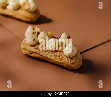 eclairs with whipped cream and hazelnuts Stock Photo