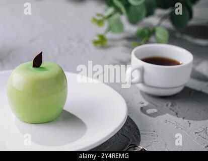 apple shaped mousse cake and tea Stock Photo