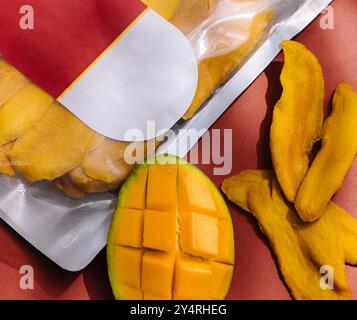 pack of dried mango slices and raw mango Stock Photo