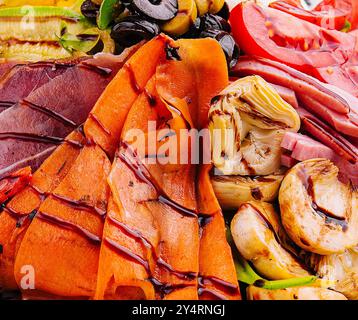 salad of various meats with mushrooms, carrots and lettuce leaves Stock Photo
