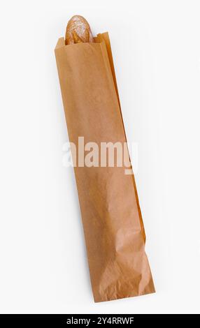 Top view of a crusty baguette peeking out from a brown paper bag ...