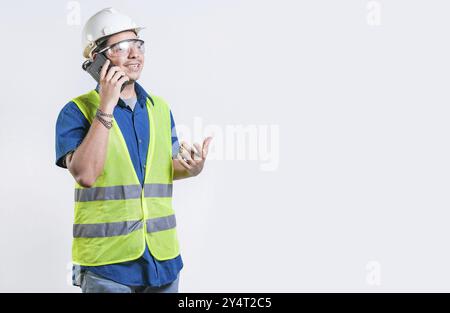 Civil engineer talking phone isolated. Young latin engineer calling on cell phone isolated Stock Photo