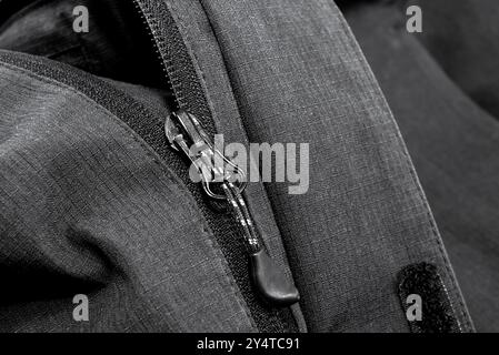 Darkr lock with black zipper on clothes close-up. Zipper Stock Photo