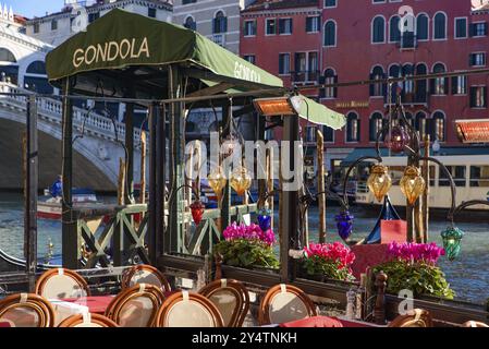 View of the Grand Canal, Rialto Bridge, and gondolas from outdoor restaurant seats, Venice, Italy, Europe Stock Photo