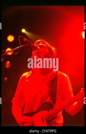 SUPERGRASS, CONCERT, 1997: Gas Coombes of Supergrass playing live at Newport Centre in Newport, Wales, UK with their second album on 10 May 1997. Photograph: Rob Watkins.   INFO: Supergrass, a British rock band, achieved success in the 1990s with their infectious blend of Britpop and punk influences. Hits like 'Alright' and albums such as 'I Should Coco' solidified their reputation for energetic, catchy tunes, contributing to the vibrant music scene of the era. Stock Photo