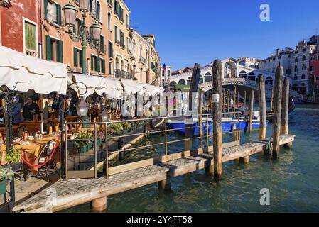 View of the Grand Canal, Rialto Bridge, and gondolas from outdoor restaurant seats, Venice, Italy, Europe Stock Photo