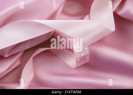 Pink satin silk background with colored ribbons Stock Photo