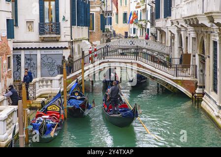 Gondola, the traditional Venetian boat, on canal with tourists, Venice, Italy, Europe Stock Photo