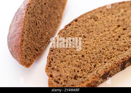Close up shot of pieces of brown bread on white background Stock Photo