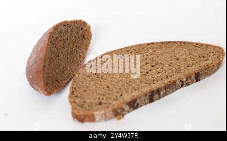 Close up shot of pieces of brown bread on white background Stock Photo