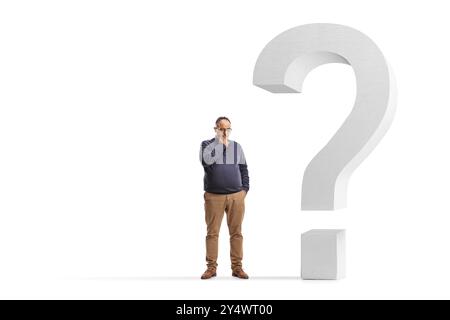 Pensive mature man next to a question mark symbol isolated on white background Stock Photo
