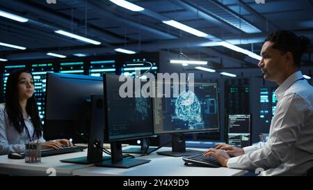 Computer scientist using AI tech on PC to do checkup in server room. IT staff member in data center using artificial intelligence technology to process datasets for training, camera B Stock Photo