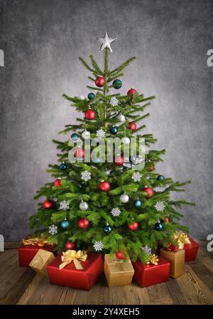 Decorated Christmas tree with gift boxes on wooden floor with gray textured wall, with red, silver and teal baubles Stock Photo