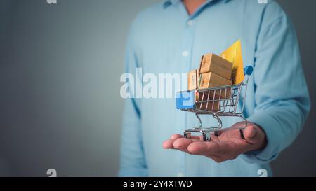 Cardboard box cargo on trolley in businessman hands, Online shopping and logistic of cargo and storage shipping business concept, Business and e-comme Stock Photo
