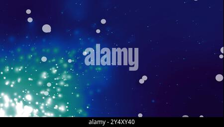 Glowing particles and light bursts image over dark blue background Stock Photo