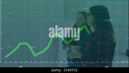 Financial graph image over two women discussing in office Stock Photo