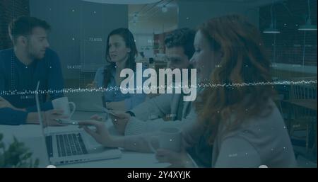 Financial data processing image over diverse business people working on laptops Stock Photo
