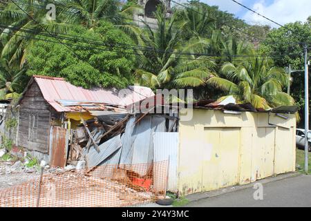 Shack homes with collapsed roof in Fort-de-France Martinique with palm trees Stock Photo