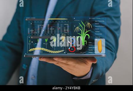 Businessman holding tablet with virtual farming map screen global strategy planning. Planning growth for success Farming innovation. Digital Applicati Stock Photo