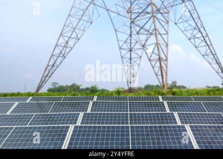 A solar panel or solar cell with high voltage electric transmission is shown on a cloudy day. The sky is overcast and the sun is not visible. Photovol Stock Photo