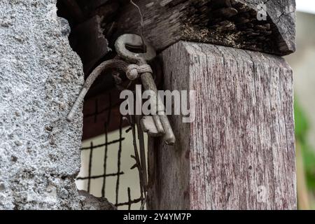 Worn antique door lock hanging on wood Stock Photo