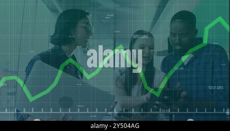 Financial graph image over diverse colleagues discussing work in modern office Stock Photo
