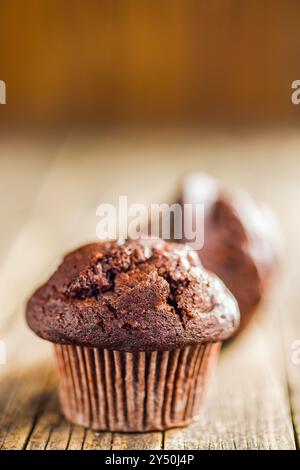 Sweet chocolate muffin cakes. Cupcakes on a wooden table. Stock Photo