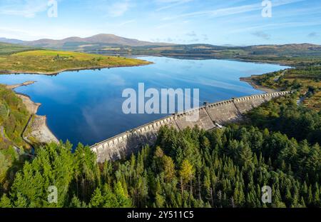 Aerial view from drone of dam on Clatteringshaws Reservoir ( loch) in Galloway Forest Park and inside proposed new Galloway National Park, Dumfries an Stock Photo