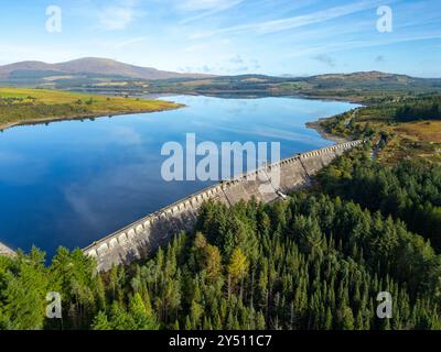 Aerial view from drone of dam on Clatteringshaws Reservoir ( loch) in Galloway Forest Park and inside proposed new Galloway National Park, Dumfries an Stock Photo