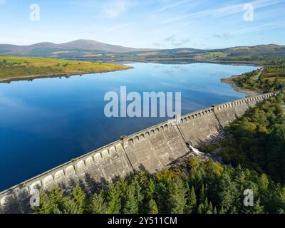 Aerial view from drone of dam on Clatteringshaws Reservoir ( loch) in Galloway Forest Park and inside proposed new Galloway National Park, Dumfries an Stock Photo