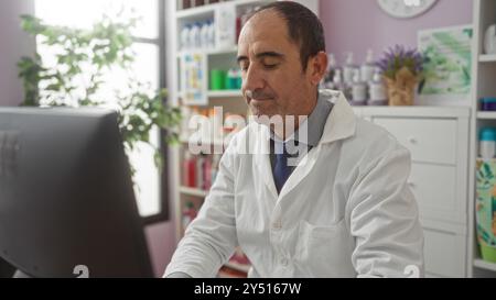 A mature hispanic bald man works in a pharmacy store wearing a white lab coat, surrounded by shelves of products, viewed from an indoor setting with n Stock Photo