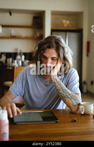 Man using tablet computer while working in office Stock Photo