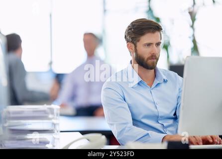Office, businessman and typing on computer for email, page update and online information. Career, male web designer and thinking with digital for Stock Photo