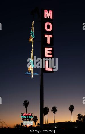 Diving woman neon sign outside motel at night Stock Photo