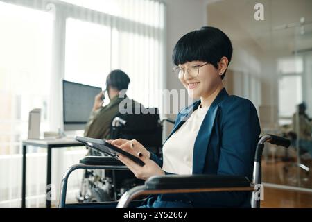 Woman With Disability Working On Tablet PC Stock Photo