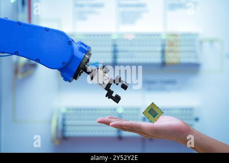 Close-up CPU chipset processor on hand human for sending to automation robot for upgrade efficiency to work on smart factory Stock Photo