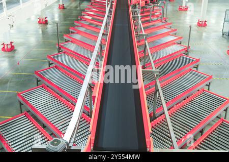Automated Conveyor Belt Sorting Mechanism in a Logistics Center. Automatic Engineering Solution Handling and Preparing Parcels for Delivery to Clients Stock Photo