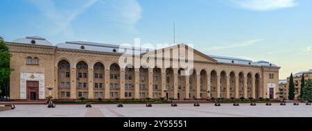 Ganja City Hall in Azerbaijan, a large beige building with an arched facade. It has many windows and a central entrance. A big plaza lies in front of it Stock Photo