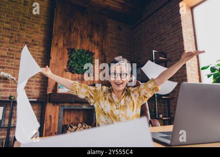 Photo of glad attractive successful lady sitting armchair celebrating project loft interior indoors workstation workspace Stock Photo