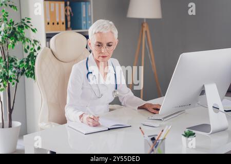 Photo of professional family doc lady browsing modern technology ...