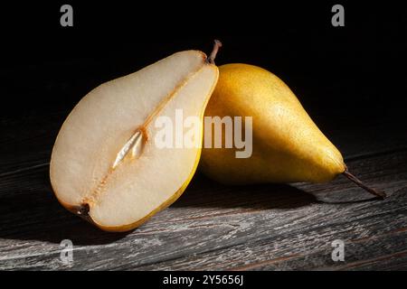 sliced yellow pears on black wood background Stock Photo