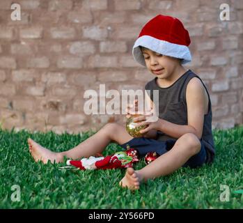 latino-boy-sitting-barefoot-on-the-floor-with-a-green-ukulele-in-his