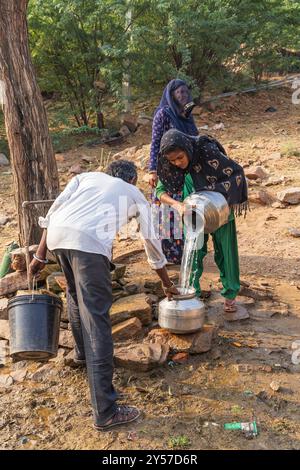 Killa, Degana, Rajasthan, India. November 9, 2022. Filling water jugs and buckets at a public faucet. Stock Photo