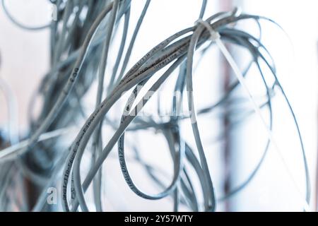 Bunches of wires, computer and network cables are connected with a clamp. Connection and network concept. High quality photo Stock Photo