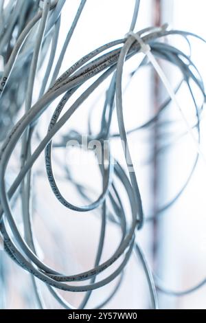 Bunches of wires, computer and network cables are connected with a clamp. Connection and network concept. High quality photo Stock Photo