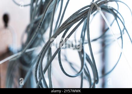 Bunches of wires, computer and network cables are connected with a clamp. Connection and network concept. High quality photo Stock Photo