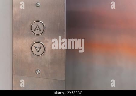 Elevator control panel. Up and down buttons on the steel surface. High quality photo Stock Photo