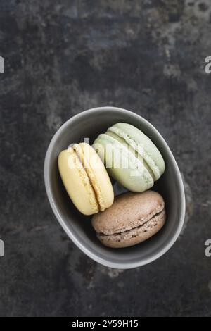 Colourful macarons in a small bowl Stock Photo